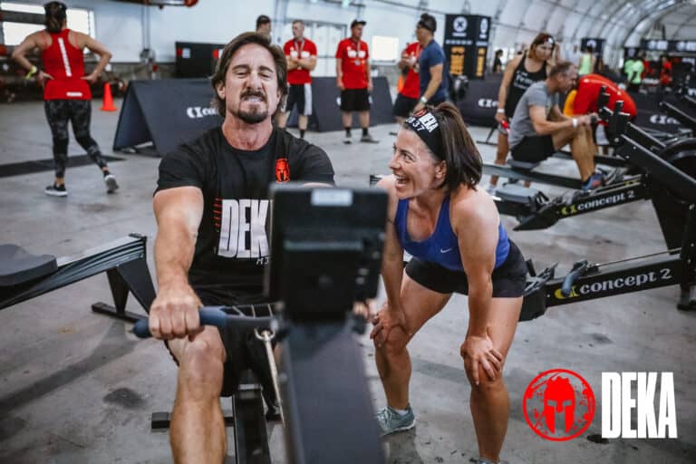 DEKA FIT teams, man rowing while woman cheers