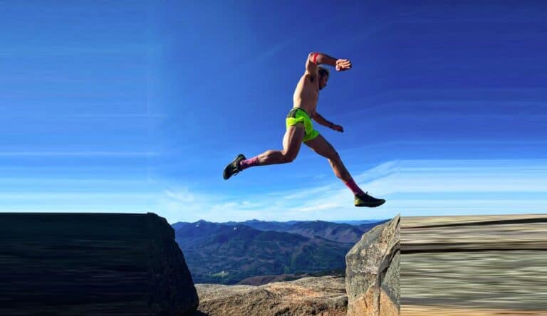 Ryan Atkins jumping rocks in the mountains