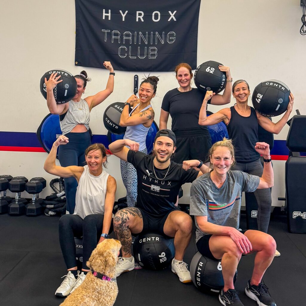 Athletes flexing after HYROX class at F45 Ballard in Seattle.